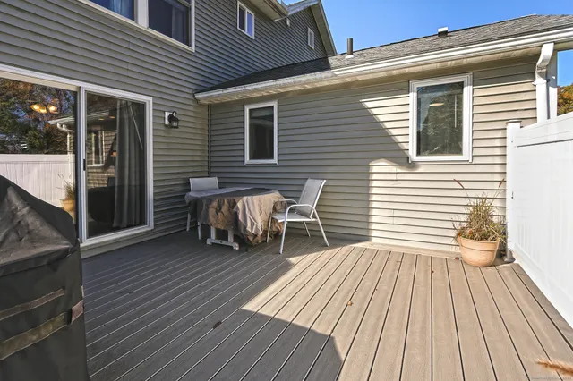 a view of a deck with table and chairs with wooden floor and fence