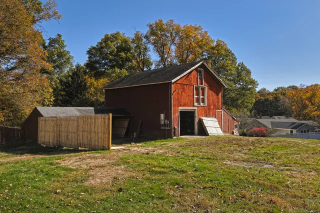 a view of a yard with wooden fence and a bench