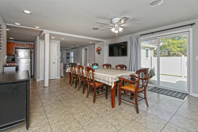 a view of a dining room with furniture and chandelier
