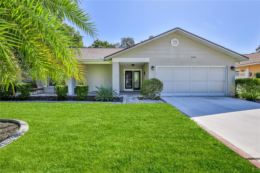 a front view of a house with a yard and garage