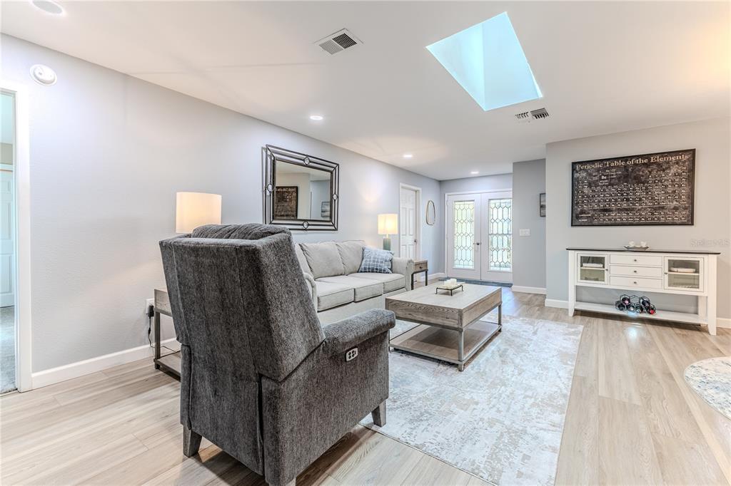6428 Plantation Road Spring Hill, FL 34606 - Photo 11 of 50 a living room with furniture and a flat screen tv