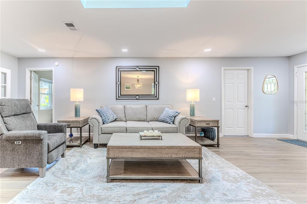 6428 Plantation Road Spring Hill, FL 34606 - Photo 12 of 50 a living room with furniture and wooden floor
