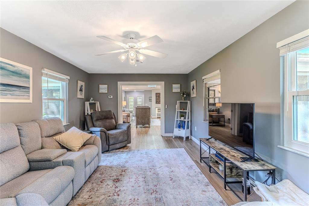 6428 Plantation Road Spring Hill, FL 34606 - Photo 17 of 50 a living room with furniture and a flat screen tv