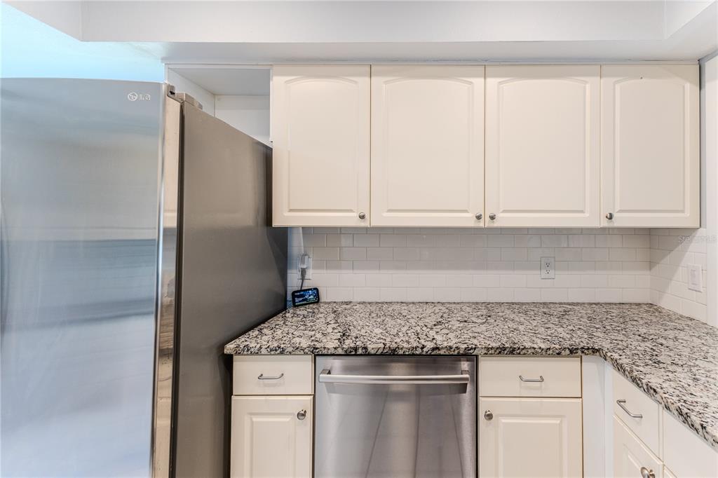 6428 Plantation Road Spring Hill, FL 34606 - Photo 24 of 50 a kitchen with granite countertop cabinets stainless steel appliances and a counter space