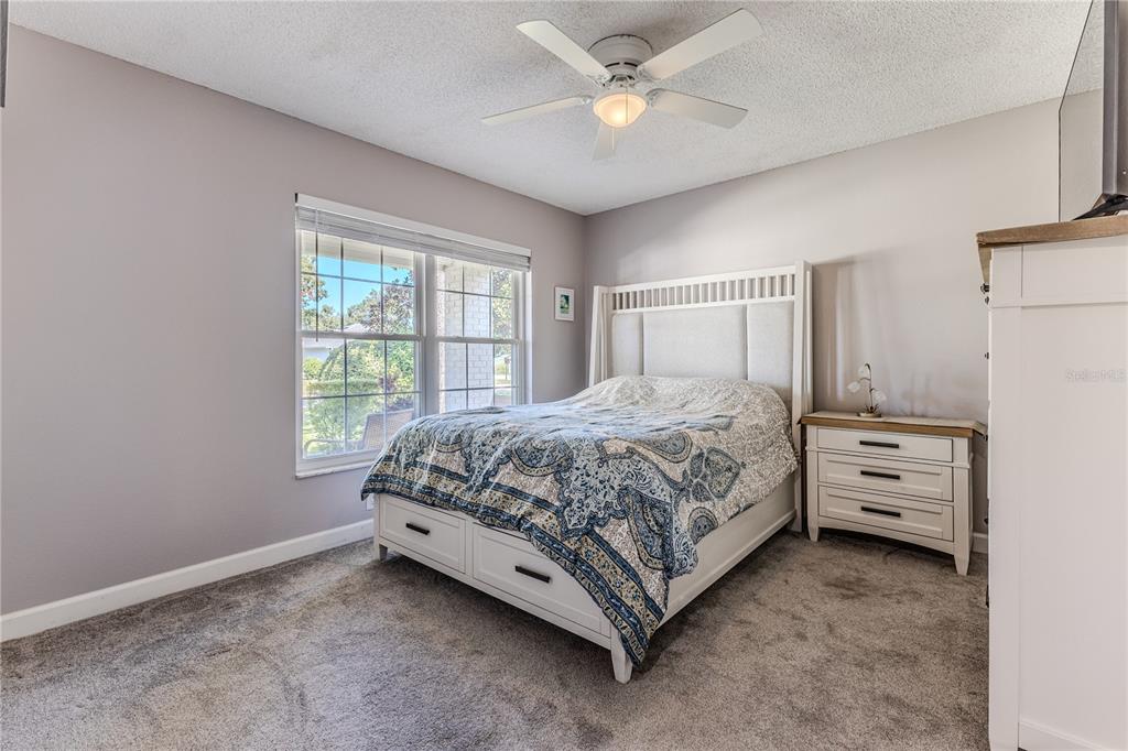 6428 Plantation Road Spring Hill, FL 34606 - Photo 27 of 50 a bedroom with a bed and a window