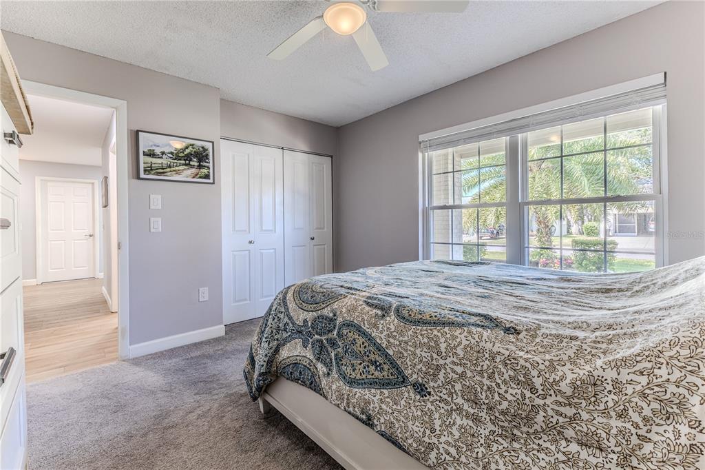 6428 Plantation Road Spring Hill, FL 34606 - Photo 28 of 50 a bedroom with a bed and a chandelier