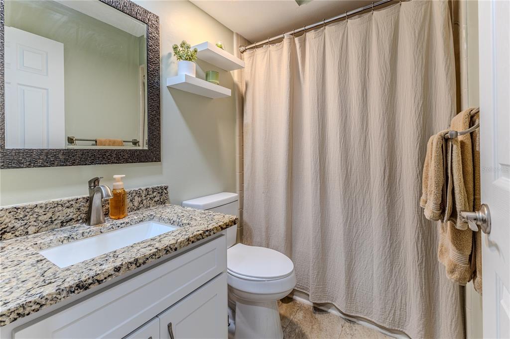 6428 Plantation Road Spring Hill, FL 34606 - Photo 29 of 50 a bathroom with a granite countertop sink and a mirror
