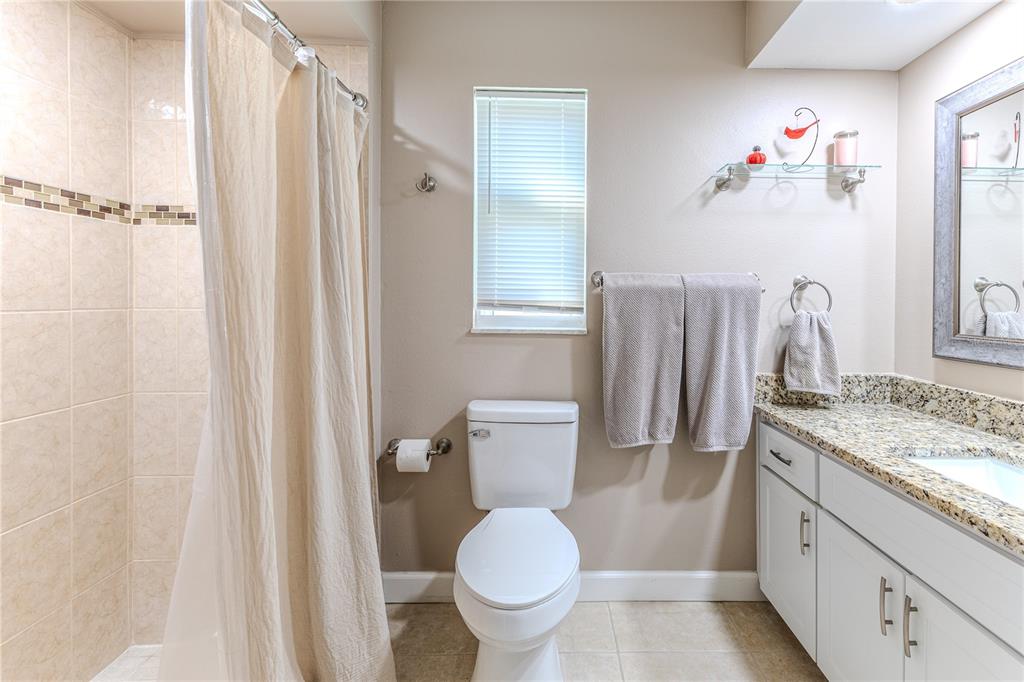 6428 Plantation Road Spring Hill, FL 34606 - Photo 36 of 50 a bathroom with a granite countertop sink toilet and shower