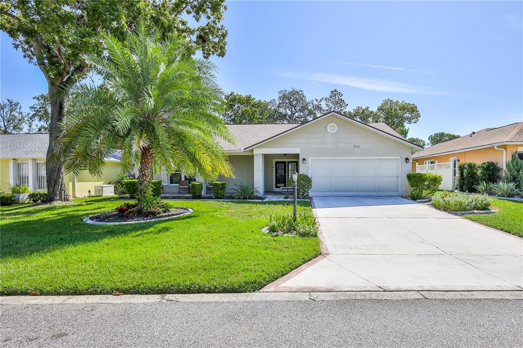6428 Plantation Road Spring Hill, FL 34606 - Photo 4 of 50 a front view of a house with a yard and garage