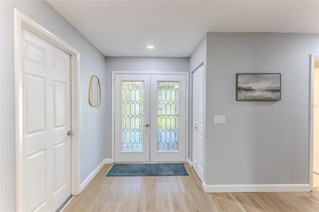 a kitchen with stainless steel appliances granite countertop white cabinets and a stove a oven with white countertops