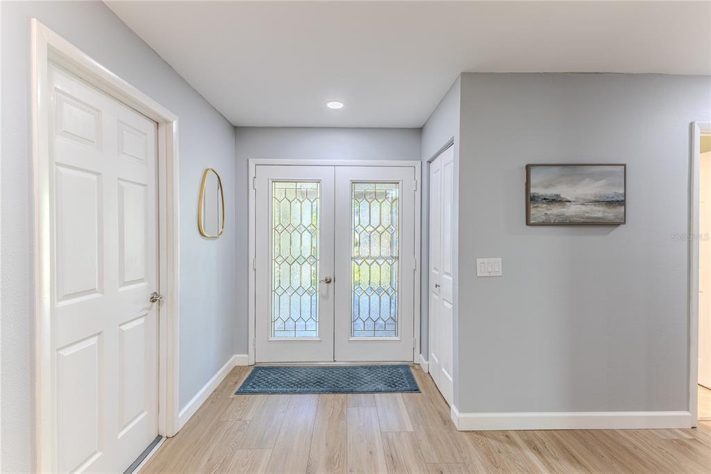 6428 Plantation Road Spring Hill, FL 34606 - Photo 8 of 50 a view of livingroom with hardwood floor and hallway