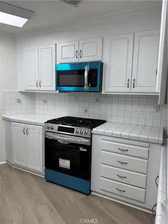 a kitchen with stainless steel appliances granite countertop a stove and a sink