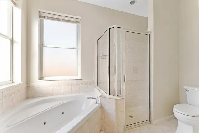 a bathroom with a bathtub a toilet and a shower