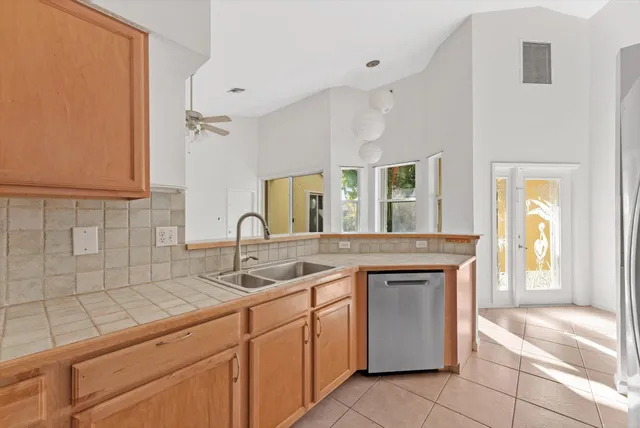 a kitchen with granite countertop a sink and cabinets