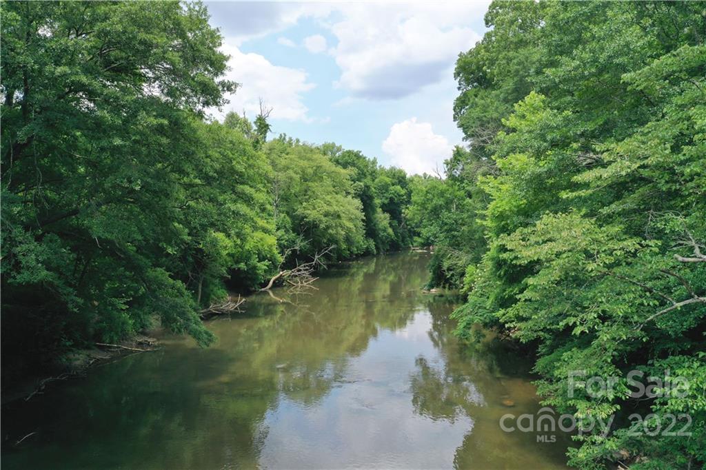 7700 Edgefield Road Concord, NC 28025 - Photo 21 of 48 a view of a lake view with a garden