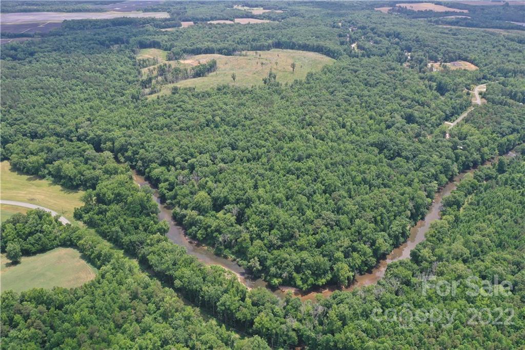 7700 Edgefield Road Concord, NC 28025 - Photo 24 of 48 a view of a forest with a street