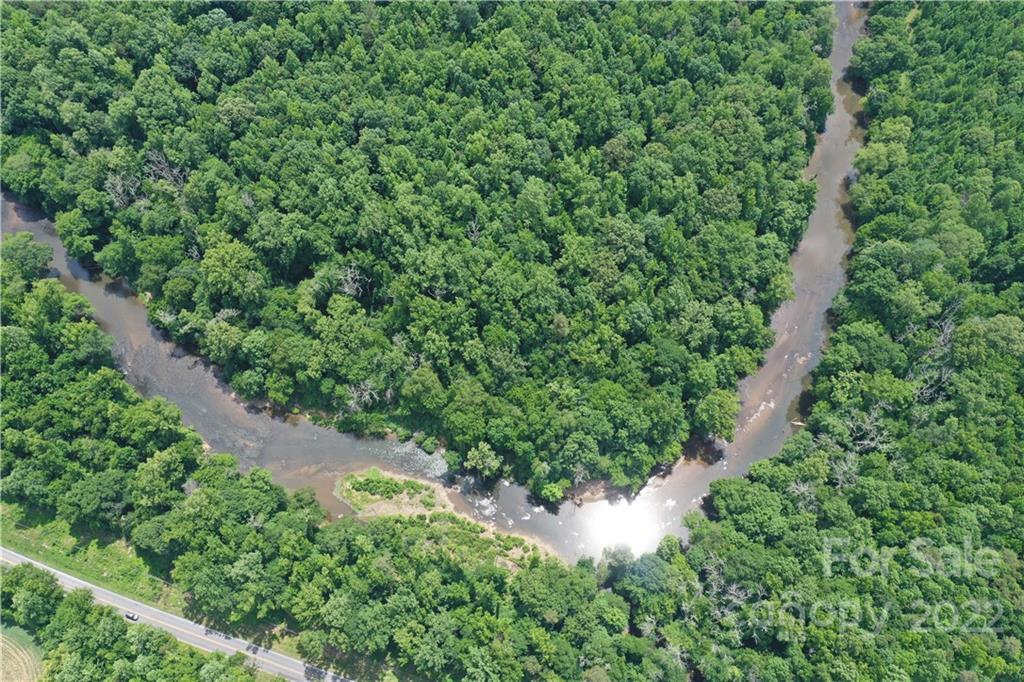7700 Edgefield Road Concord, NC 28025 - Photo 25 of 48 a view of a lush green forest with lots of trees