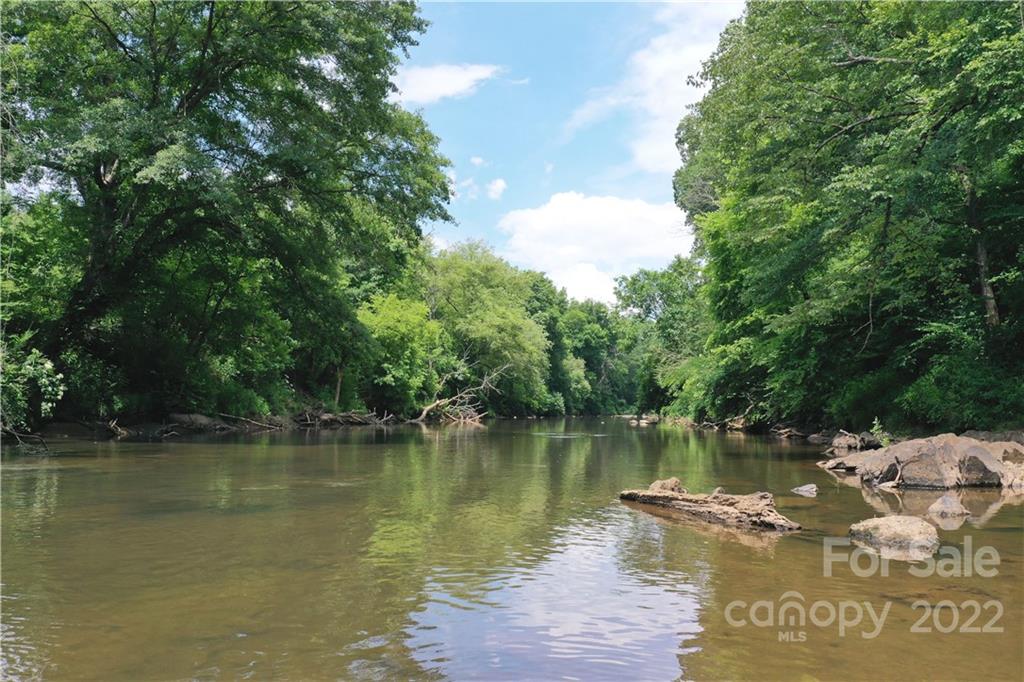 7700 Edgefield Road Concord, NC 28025 - Photo 27 of 48 a view of a water pond with green trees