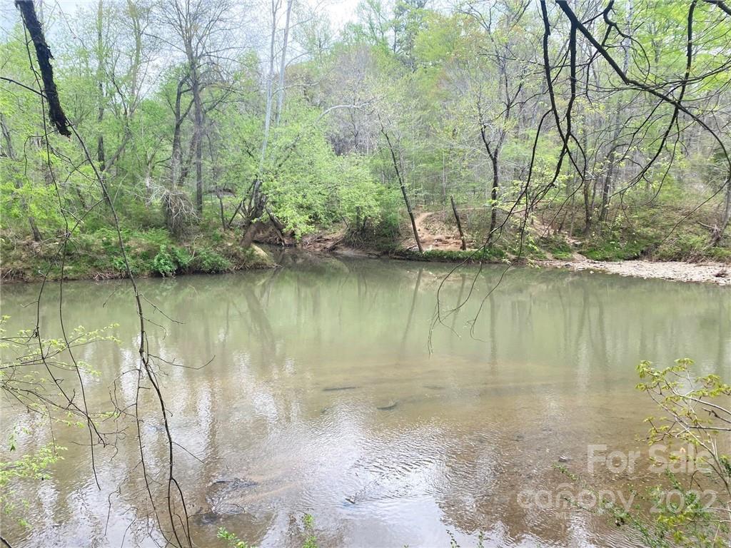 7700 Edgefield Road Concord, NC 28025 - Photo 32 of 48 a view of a lake with houses in the background