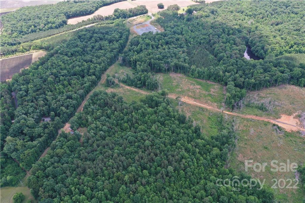 7700 Edgefield Road Concord, NC 28025 - Photo 7 of 48 an aerial view of residential houses with outdoor space and trees