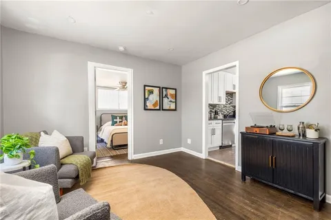 a living room with furniture and a mirror
