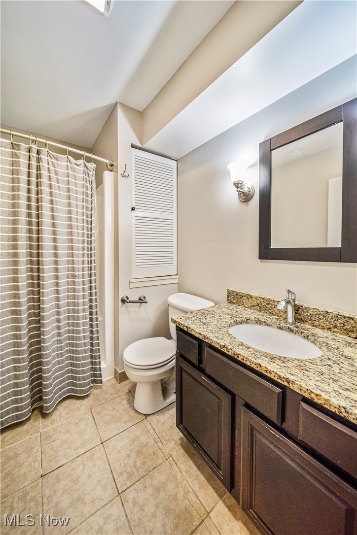 1796 Lander Road Mayfield Heights, OH 44124 - Photo 19 of 39 Bathroom with vanity, toilet, a shower with shower curtain, and tile patterned floors