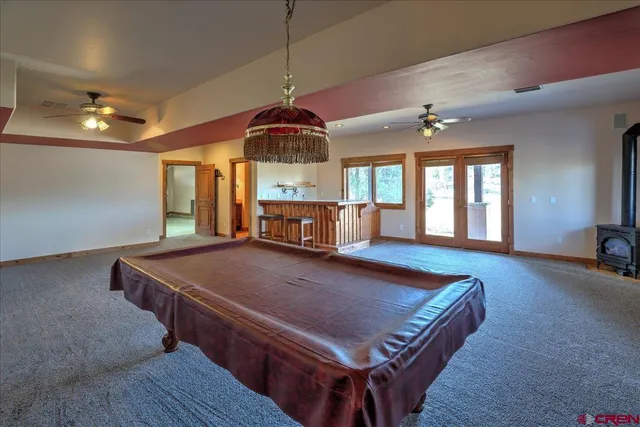 a living room with stainless steel appliances granite countertop furniture rug and window
