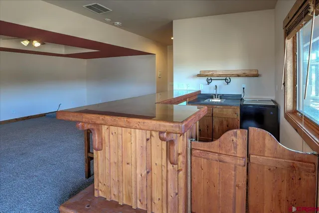 a kitchen with stainless steel appliances kitchen island sink refrigerator and stove