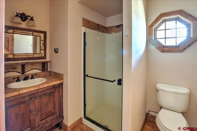 a bathroom with a sink toilet and mirror