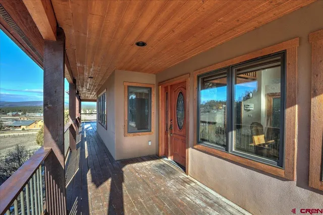 a bedroom with furniture and large windows