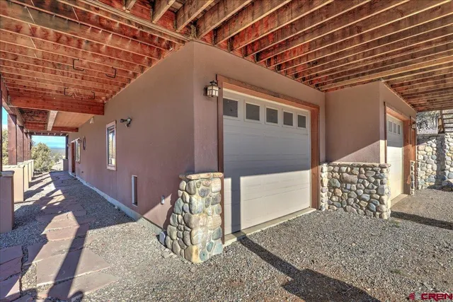 a view of a table and chairs under an umbrella