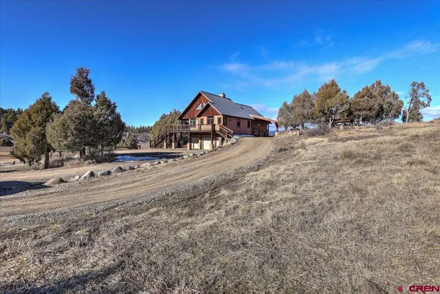 a view of a dirt road with a building in the background