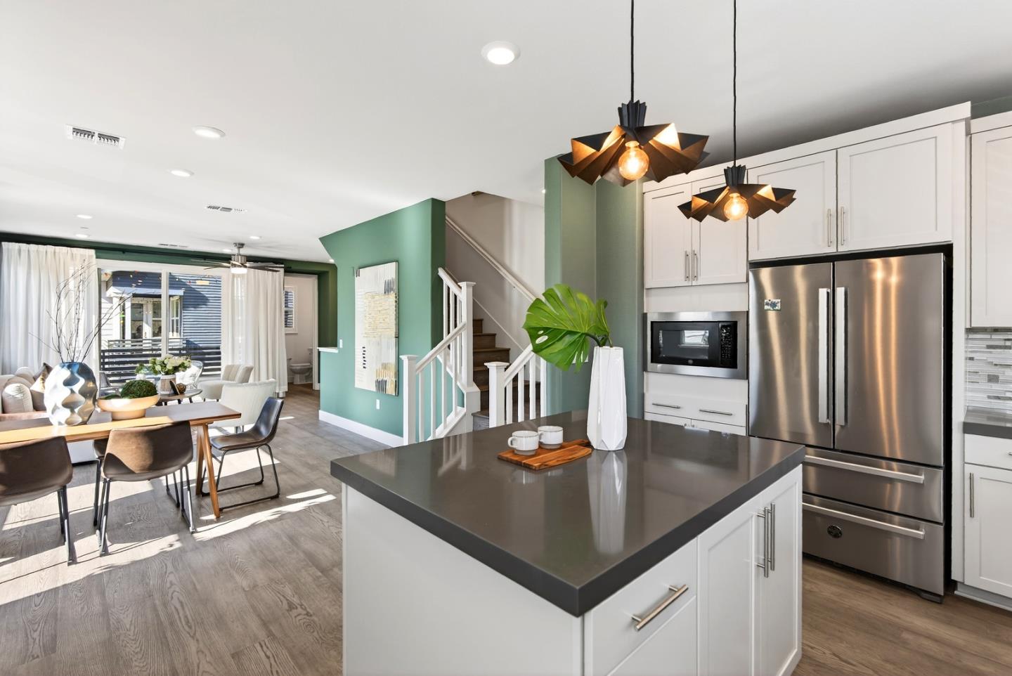 2268 Mora Place Mountain View, CA 94040 - Photo 18 of 38 a kitchen with stainless steel appliances granite countertop a table chairs and a refrigerator