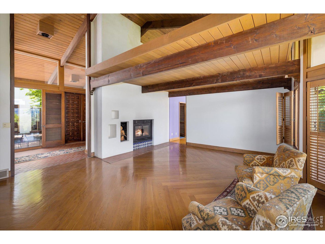 400 Ord Drive Boulder, CO 80303 - Photo 12 of 39 Gleaming hardwood floors in living room w/ wood burn fireplace