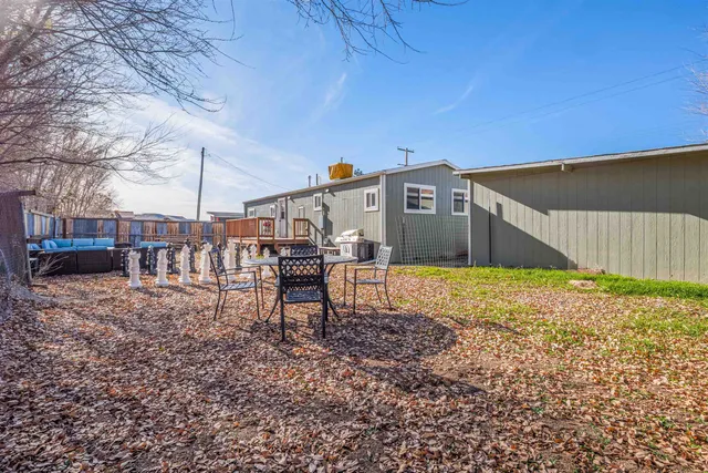 a front view of a house with a yard and wooden fence