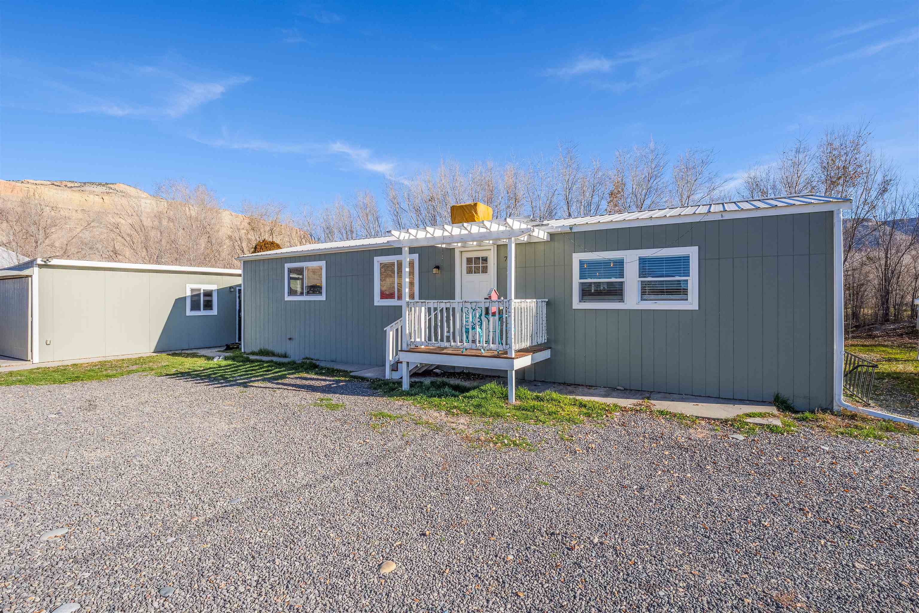 702-37 37 1/10 Road Palisade, CO 81526 - Photo 4 of 42 a backyard of a house with barbeque oven and outdoor seating