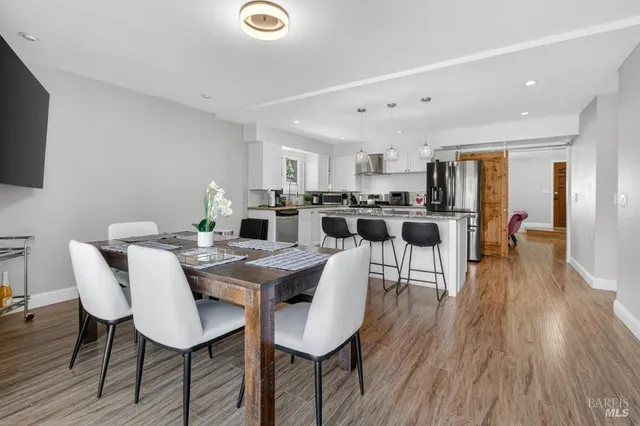 a view of a dining room with furniture window and wooden floor