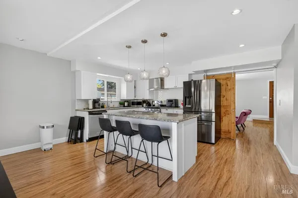 a utility room with lots of clutter and cabinets