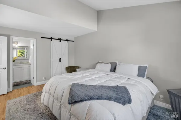 a view of a livingroom with wooden floor and stairs