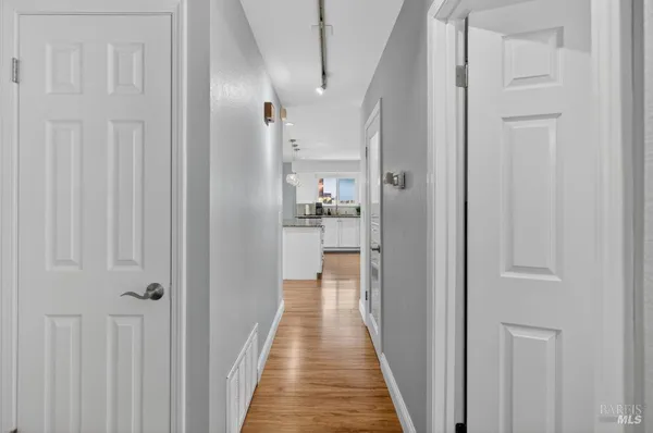 a view of hallway with wooden floor
