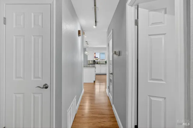 a view of hallway with wooden floor
