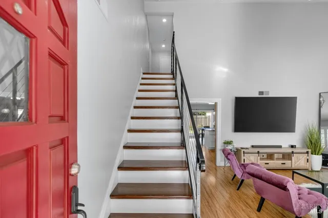a bed room with a bed and a flat tv screen