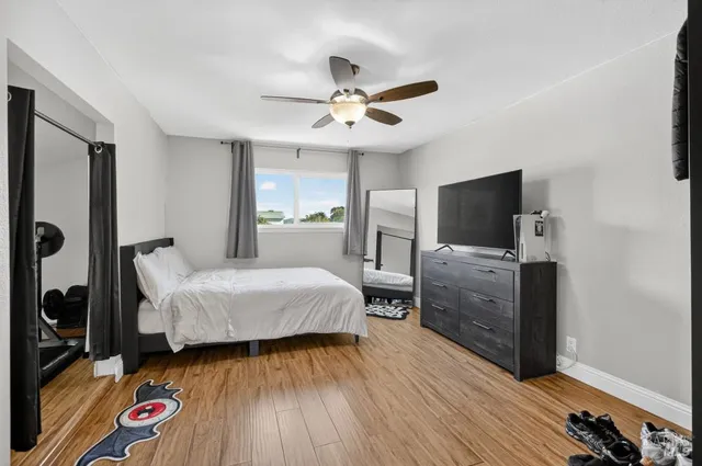 a bedroom with a bed and a television