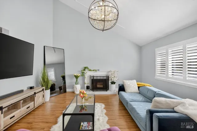 a living room with furniture or wooden floor and a flat screen tv