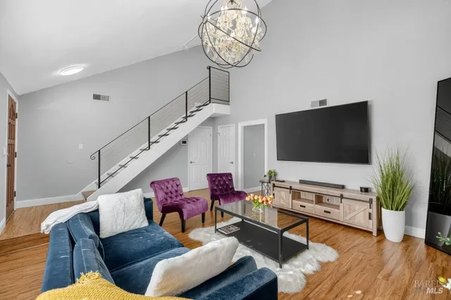 a living room with furniture a fireplace and a flat screen tv