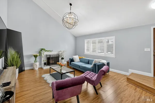 a living room with furniture a fireplace and a window