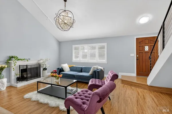 a living room with furniture and a potted plant