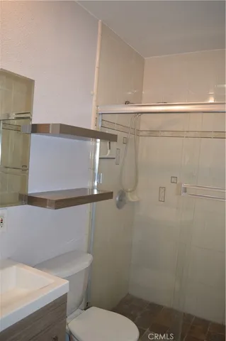 a bathroom with a toilet and a shower