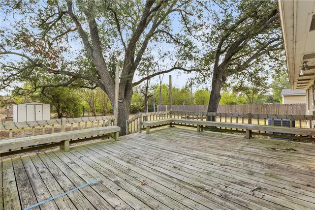 a view of a wooden deck with trees