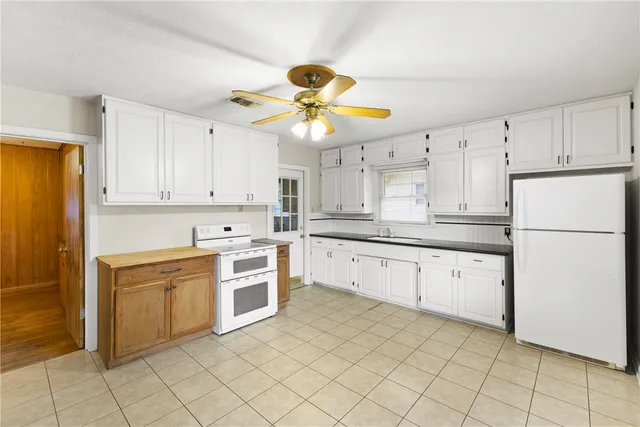 a kitchen with cabinets stainless steel appliances and a sink